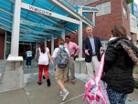 New Bedford superintendent of schools, Thomas Anderson, and mayor of New Bedford, Jon Mitchell, welcome students back to school in front of the Irwin Jacobs elementary school in New Bedford. [ PETER PEREIRA/THE STANDARD-TIMES/SCMG ]